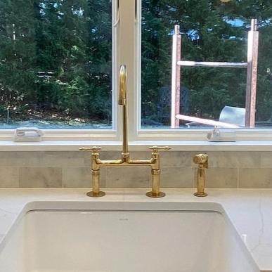 Unlacquered Brass Bridge Kitchen Sink Faucet with Sprayer.