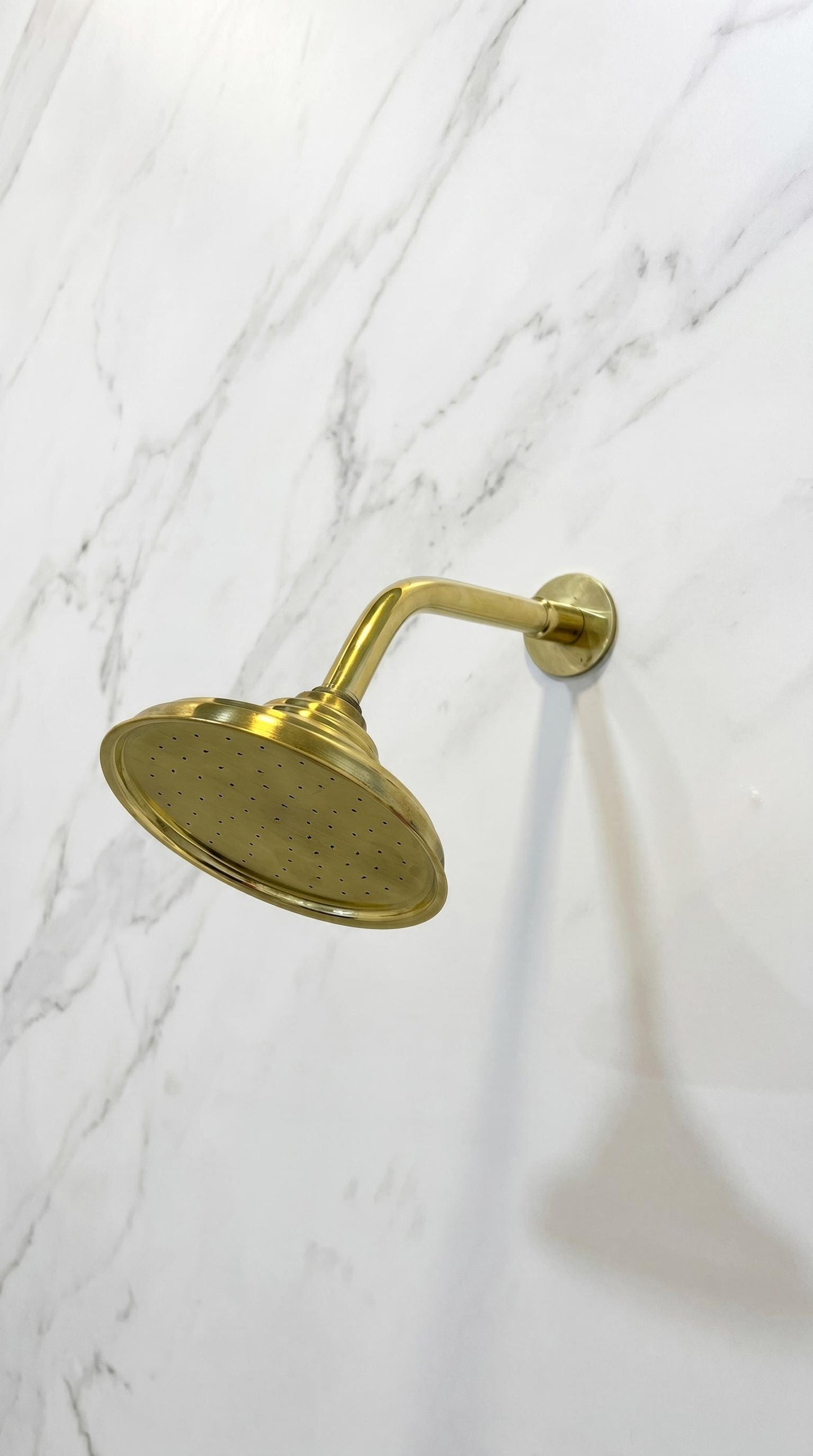 Unlacquered Brass Standard Shower Arm Extension With Shower Head.